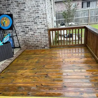 A wood deck in the Hattiesburg area just after a soft-wash — rich, clean boards