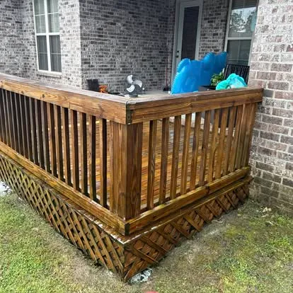 Same wood railing after soft washing and restoration, rich brown color